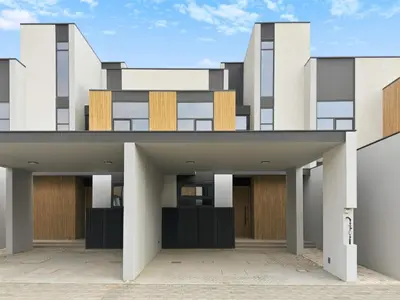 an external view of a building with wooden doors at Incredible Family Townhouse Villa I Sleeps 10 in Dubai
