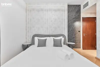 a bedroom with a large white bed with white pillows at bnbmehomes - 29 Boulevard Tower 1 in Dubai