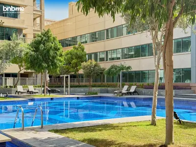 a swimming pool in front of a building at bnbmehomes - 29 Boulevard Tower 1 in Dubai