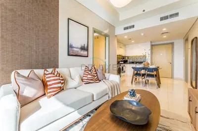 a living room with a white couch and a wooden table at Minutes from Downtown Dubai and Burj Khalifa, Easy Metro Access, Seamless Connectivity to Marina and Palm Jumeirah - Aykon City 2 Tower C, Business Bay by Deluxe Holiday Homes in Dubai