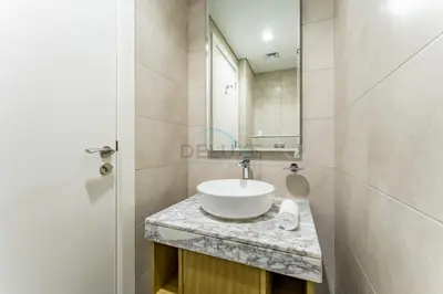 a bathroom with a sink and a mirror at Minutes from Downtown Dubai and Burj Khalifa, Easy Metro Access, Seamless Connectivity to Marina and Palm Jumeirah - Aykon City 2 Tower C, Business Bay by Deluxe Holiday Homes in Dubai