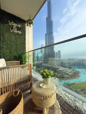 a balcony with a table and a view of a city at Breathtaking 2Bedroom front-row Burj Khalifa & Fountain Views from Balcony, Grande Signature Residences in Dubai