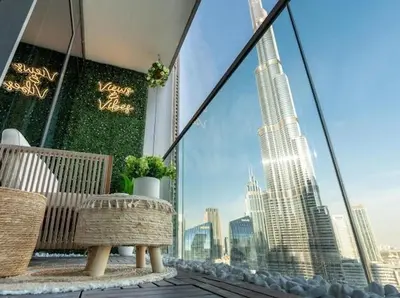 a balcony with a bench and a view of a city at Breathtaking 2Bedroom front-row Burj Khalifa & Fountain Views from Balcony, Grande Signature Residences in Dubai