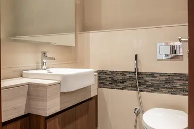 a bathroom with a sink and a toilet and a shower at Iconic Burj Khalifa View - Elegant 1BR Apartment in Dubai