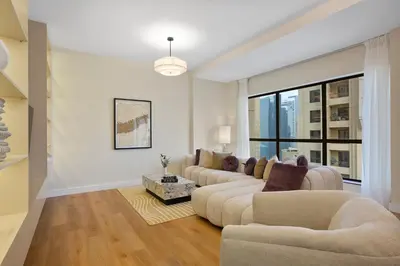 a living room with two couches and a large window at Designer 2Bedroom in Rimal near to JBR Beach in Dubai