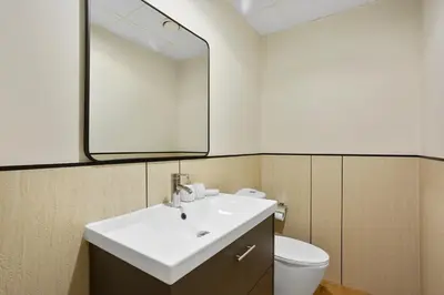 a bathroom with a sink and a mirror and a toilet at Designer 2Bedroom in Rimal near to JBR Beach in Dubai