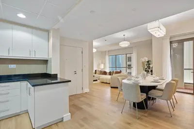 a kitchen and living room with a table and chairs at Designer 2Bedroom in Rimal near to JBR Beach in Dubai