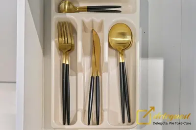 a plastic tray with utensils in a drawer at Modern Comfort Studio DAMAC Hills 1 in Dubai