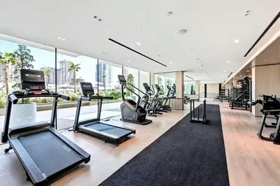a gym with treadmills and ellipticals in a building at Vogue JVC Binghatti Phoenix near Circle Mall, Studio Apartment with Balcony and Access to all Amenities in Dubai