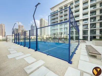 a tennis court in front of a building at Vogue JVC Binghatti Phoenix near Circle Mall, Studio Apartment with Balcony and Access to all Amenities in Dubai