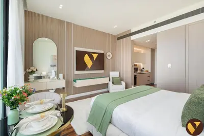 a bedroom with a bed and a table with plates on it at Vogue JVC Binghatti Phoenix near Circle Mall, Studio Apartment with Balcony and Access to all Amenities in Dubai