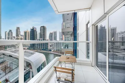 a balcony with two chairs and a view of the city at ShoresInn - Sleek & Modern Stay at Dubai Marina in Dubai