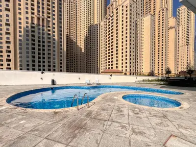 a pool in the middle of a city with tall buildings at ShoresInn - Sleek & Modern Stay at Dubai Marina in Dubai