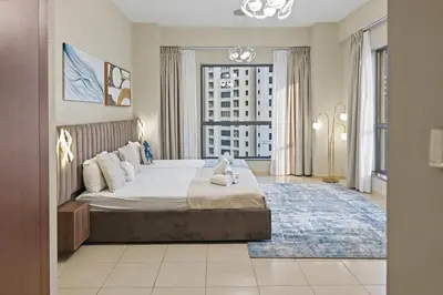 a bedroom with a large bed and a large window at Luxury 2BR l High Floor l Marina View l JBR in Dubai
