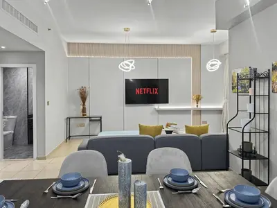 a living room with a couch and a tv at Luxury 2BR l High Floor l Marina View l JBR in Dubai