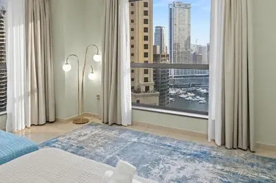 a bedroom with a large window with a view of a city at Luxury 2BR l High Floor l Marina View l JBR in Dubai