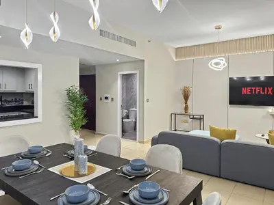 a living room with a table and a couch at Luxury 2BR l High Floor l Marina View l JBR in Dubai