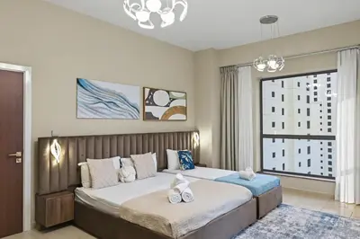 a bedroom with a large bed and a large window at Luxury 2BR l High Floor l Marina View l JBR in Dubai
