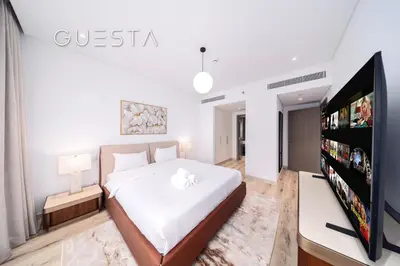 a bedroom with a bed and a flat screen tv at Myrtle Central Park, City Walk Dubai in Dubai