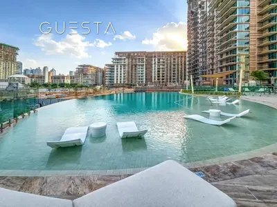 a large swimming pool with chairs in a city at Myrtle Central Park, City Walk Dubai in Dubai