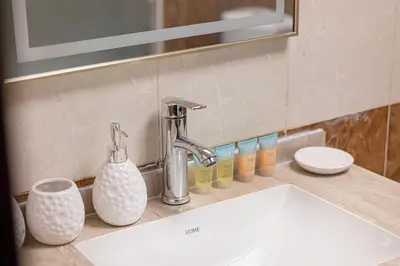 a bathroom sink with a faucet and other items on a counter at FiveX Luxury 2BR at Lake Point JLT in Dubai