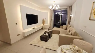 a living room with a couch and a tv at Skyline Vida Dubai Mall 3 Bedroom Apartment I Burj Khalifa Views I Direct Access Dubai Mall I Parking, Gym, Wi-Fi & Pool in Dubai