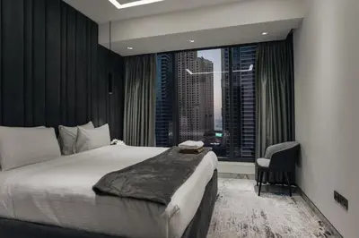 a bedroom with a large bed and a window at Luxury 2BR Huge New Apartment in Dubai
