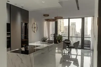 a kitchen with a table and a dining room at Luxury 2BR Huge New Apartment in Dubai