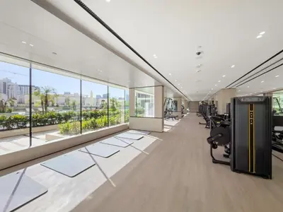 an office with a large room with windows at Modern Studio in Prime JVC Padel, Pool & Gym in Dubai