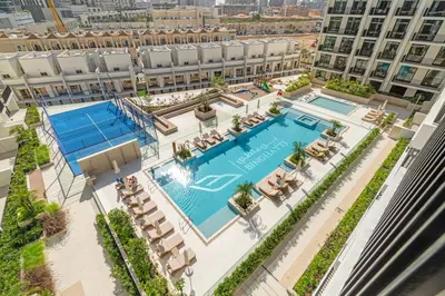 an overhead view of the pool at the resort at Modern Studio in Prime JVC Padel, Pool & Gym in Dubai