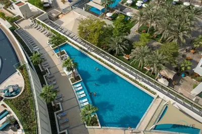 an overhead view of a swimming pool with palm trees at 2BR Address JBR - Direct Beach Access & Top Views in Dubai