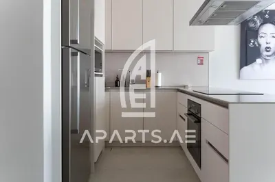 a kitchen with white cabinets and a staircase in it at 2BR Address JBR - Direct Beach Access & Top Views in Dubai