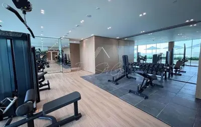a gym with treadmills and exercise equipment in a building at Luxury 1BR Binghatti JVC in Dubai