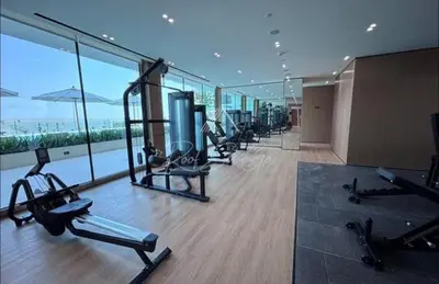 a gym with a row of exercise bikes in a building at Luxury 1BR Binghatti JVC in Dubai