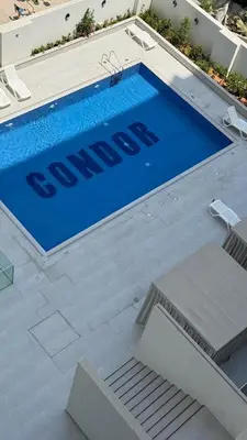 a swimming pool with a sign on top of it at Stunning Brand New Stylish Studio in JVC in Dubai