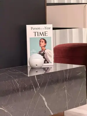 a glass table with a magazine on top of it at HYDE WALK STUDiO BURj ViEW & PREMiUM COMFORt in Dubai