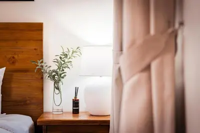 a bedroom with a lamp and a table with a plant at DIFC 1 Bed, City View, 600m to Metro, Sleeps 4 in Dubai