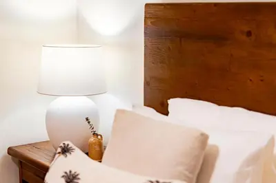 a lamp sitting on a table next to a bed at DIFC 1 Bed, City View, 600m to Metro, Sleeps 4 in Dubai