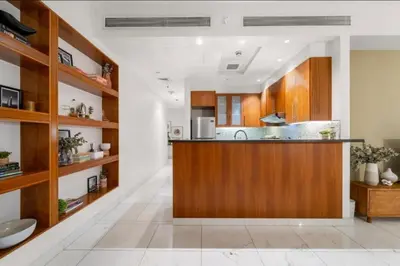 a kitchen with wooden cabinets and a counter top at DIFC 1 Bed, City View, 600m to Metro, Sleeps 4 in Dubai