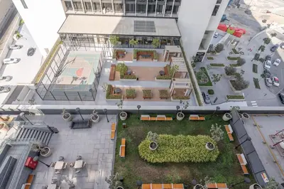 an overhead view of a building with a garden at Premium 1BHK Apartment Nobles Tower by Czechin in Dubai