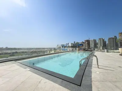 a swimming pool on the roof of a building at Premium 1BHK Apartment Nobles Tower by Czechin in Dubai