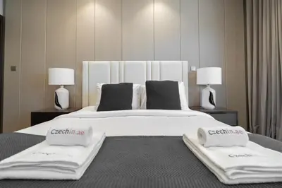 a large white bed with two pillows on it at Premium 1BHK Apartment Nobles Tower by Czechin in Dubai