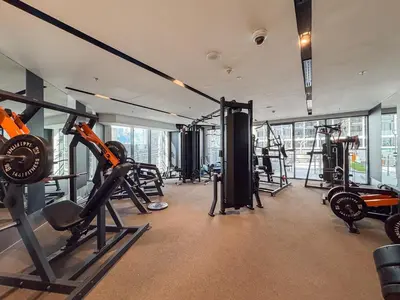 a gym with treadmills and machines in a building at Premium 1BHK Apartment Nobles Tower by Czechin in Dubai