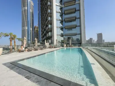 a swimming pool in the middle of a building at Premium 1BHK Apartment Nobles Tower by Czechin in Dubai