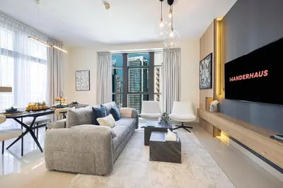 a living room with a couch and a tv at Chic 1BR near Burj Khalifa - Downtown in Dubai