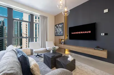 a living room with a couch and a flat screen tv at Chic 1BR near Burj Khalifa - Downtown in Dubai