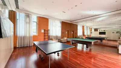 a large room with two ping pong tables in it at Chic 1BR near Burj Khalifa - Downtown in Dubai
