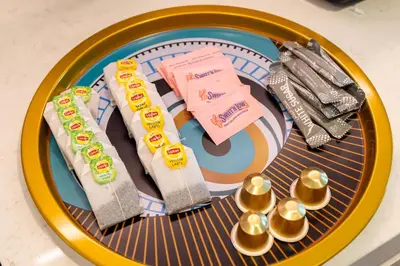a plate with chopsticks and utensils on a table at Seaside 1-Bedroom Apartment with Beach Access at Port De La Mer in Dubai
