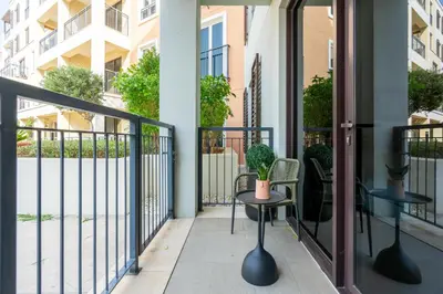 a balcony with two chairs and a table at Seaside 1-Bedroom Apartment with Beach Access at Port De La Mer in Dubai