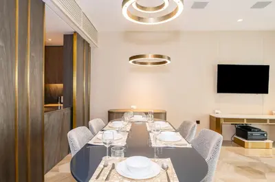 a dining room with a long table and chairs at New Arabian Five Palm Residences in Dubai